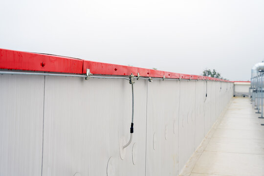 Lightning protection wires along parapet wall close up selective focus