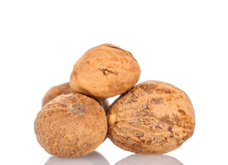 Several nutmegs, macro, isolated on white background.