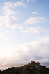 Steps leading up to Gaztelugatxeko, a church build on a cliff in the sea. The photo was taken just before sunset. The sun is casting its last light on the cliff and creating a glowing sky.