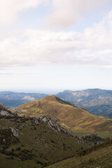 A view from the Picos de Europa National Park in Asturias Spain. The view is over the mountain peaks and towards the Cantabrian Sea. A valley is present in the foreground with a large mountain peak.