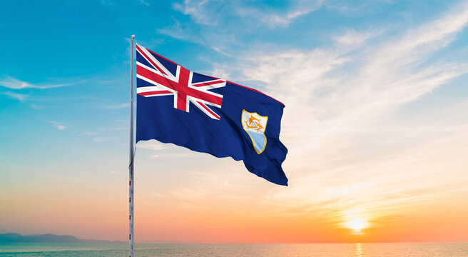 Waving flag of Anguilla against the background of a sunset or sunrise. Anguilla sky with flying flag beauty. Concept of national holidays. Anguilla flag for Independence , Commemoration Day.
