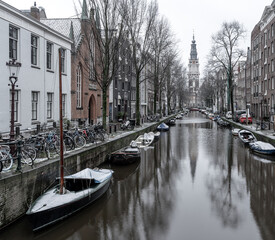 Fototapeta premium Amsterdam in Winter, Snowy Views of the Canal and the Zuiderkerk church