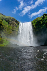 skogafoss waterfall, iceland in summer with rainbow