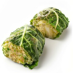 Obraz premium Two halves of savoy cabbage rolls stuffed with chopped vegetables presented on a white background