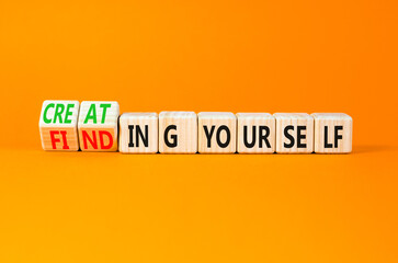 Finding or creating yourself symbol. Concept words Finding yourself or Creating yourself on beautiful wooden blocks. Beautiful orange background. Business creating yourself concept. Copy space.