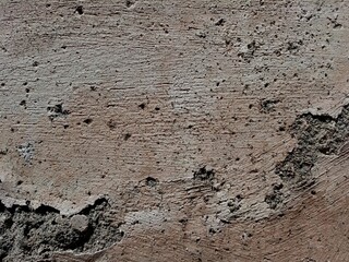 Cracked concrete wall covered with gray cement surface as background, abstract, grunge