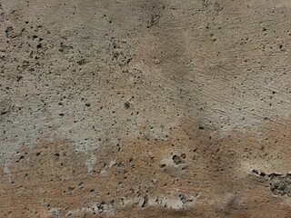 Cracked concrete wall covered with gray cement surface as background, abstract, grunge