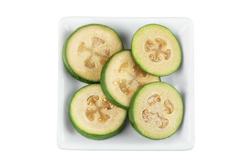 Feijoa fruit in ceramic bowl isolated on white background. Top view. Flat lay