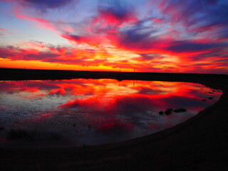 Reddish summer sunset over a lake in northern Spain