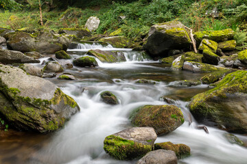 Obraz premium Long exposure of a waterfall on the East Lyn river at Watersmeet in Exmoor National Park