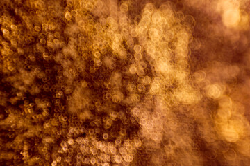 Abstract circular bokeh background of light. Shiny golden light sparkle texture