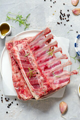 Raw fresh lamb ribs ready for roasting with spices and herbs.top veiw.