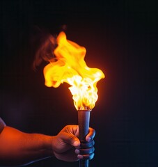 Powerful symbol of light and hope - hand holding a flare in darkness. Black History Month