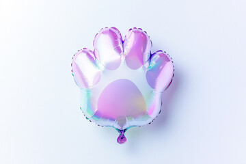 shiny holographic balloon shaped like paw print, perfect for celebrations. Its vibrant colors and unique design add playful touch to any event