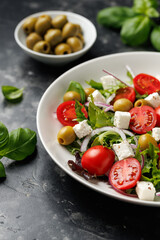 Fresh Mediterranean salad with feta cheese, tomato, olives, onion and basil leaves, Healthy home made food