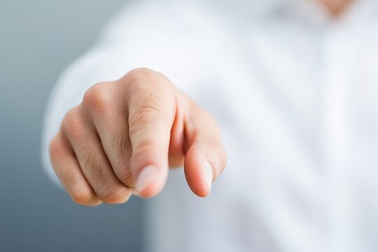 Person pointing towards the viewer, suggesting engagement and attention in a professional setting