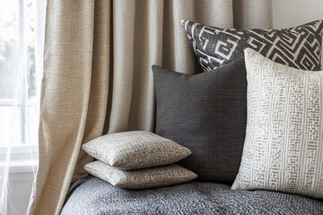 Decorative pillows and elegant curtains adorn a cozy living space highlighting modern interior design elements