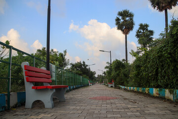 View of walkway and bench in the park in chennai