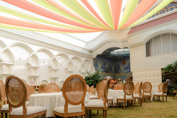 Wedding reception, table setting and celebration event with flower arrangement, decor and catering for a romantic setting. Party, luxury restaurant or fancy place with cutlery