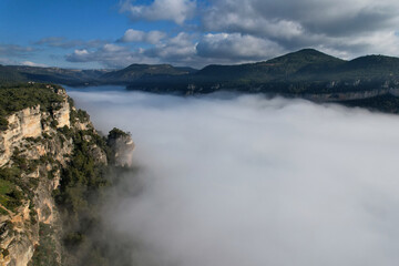 Rocks of Siurana village above the clouds on sunny winter day. Tarragona Province, Spain.