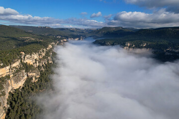 Aerial view of Siurana's rocks above the clouds on sunny winter day. Tarragona Province, Spain.