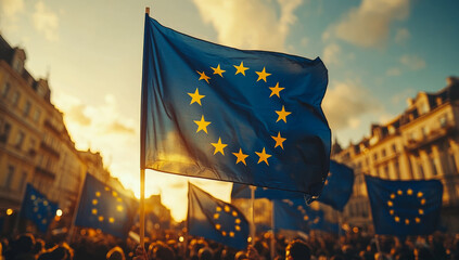 A group of people are holding up a blue and yellow flag with stars. The flag is from the European Union