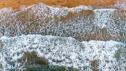 Aerial view of waves breaking on the sand of the beach in the Calblanque Regional Park, Cartagena, Region of Murcia, Spain