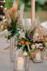 A romantic white beach wedding celebration with an outdoor ceremony, featuring elegant decor, a bottle for colored sand rituals, and a beautifully arranged table under the open sky