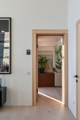 The modern interior has a bright doorway, balancing elegance and comfort in an inviting way