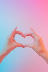Fototapeta premium flat lay of hands forming heart shape on gradient surface transitioning from pastel pink to blue