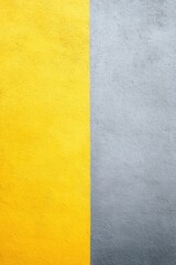 Fototapeta premium portrait-style photo of wall divided into two tones with one side painted bright yellow and other soft gray