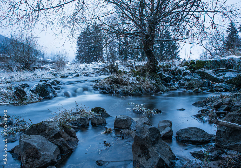 Poster winter landscape with frozen stream and bare tree in a tranquil setting at dusk