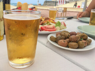 beer and appetiser on table in sunny summer day