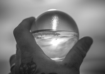 hand holding glass sphere black and white #2