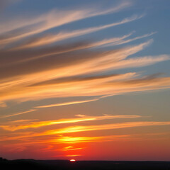 Naklejka premium Vibrant sunset with warm golden hues of orang colour