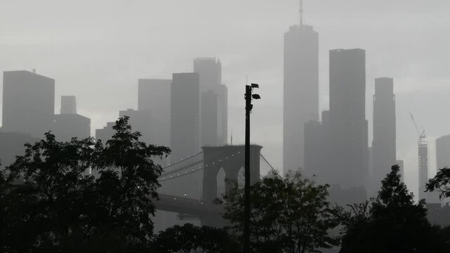 Brooklyn Bridge, rainy foggy day. New York City Manhattan downtown skyline architecture, financial district cityscape, United States. World Trade Center, WTC skyscraper view from Dumbo. Autumn in USA.