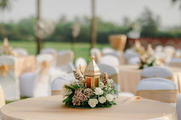 A romantic white beach wedding celebration with an outdoor ceremony, featuring elegant decor, a bottle for colored sand rituals, and a beautifully arranged table under the open sky