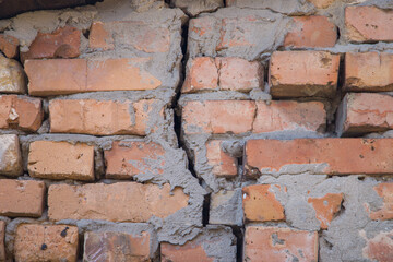 Old brick wall with a crack in it.