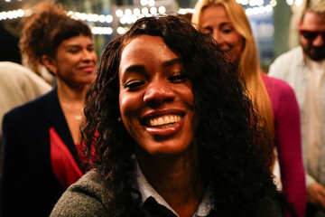 Young woman smiling with friends at party