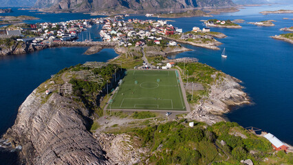 Aerial view of Henningsvaer typical norwegian village on a fjordn with in a summer day