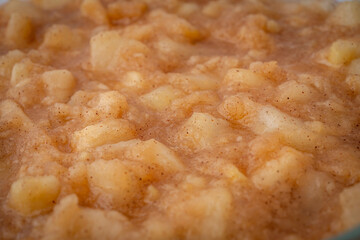 Gennevilliers, France - 01 02 2024: Still life. Close up of an apple and pear compote in a glass container.