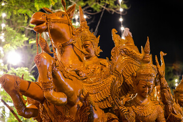 Fototapeta premium Ubon Ratchathani, Thailand - July 21, 2024: Buddhist Lent tradition, people organize a candle procession and beautiful wisdom performance, which is a unique beeswax candle to create art as a Buddhist 