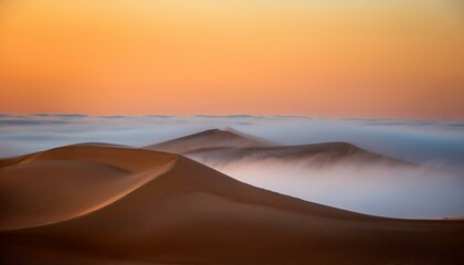 top of a huge sand dune rising from a thick cloud of fog after dawn liwa desert abu dhabi united arab emirates