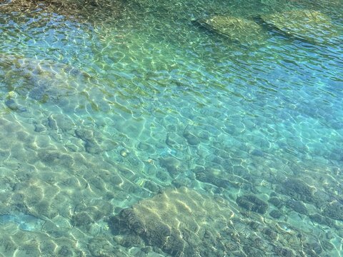 Mediterranean sea transparent water with underwater stones and pebbles