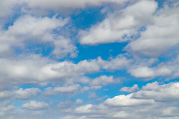 A few light cumulus clouds in a clear blue sky. summer bright image of the sky.