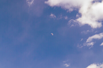 A few light cumulus clouds in a clear blue sky. summer bright image of the sky.