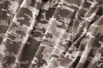 Texture of Dark green pixel camouflage military uniform textile cloth with folds