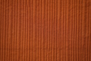 Bright orange fabric background from a piece of crumpled clothes