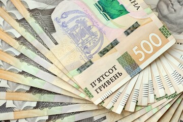 Big amount of different ukrainian hryvnia currency money bills in pile