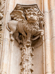 Stone carving of a winged beast on the historic architecture of Salamanca, Spain